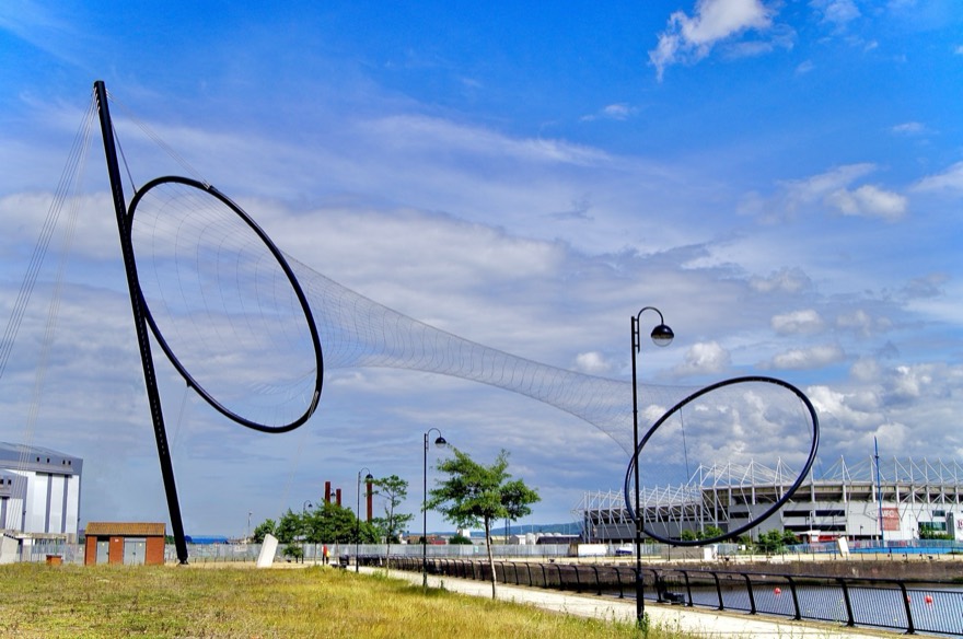 Temenos sculpture taken from the south west, showing Middlesbrough F.C. Riveside Stadium in the background.