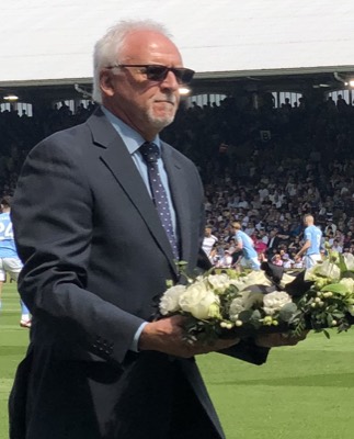 The conclusion of Viv Busby's Moment of Silence with two former Fulham players walked off the pitch, as the match between Fulham and Manchester City went underw