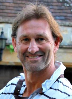 Portrait of Tony Adams holding a dog